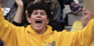boy in yellow cheering so happy