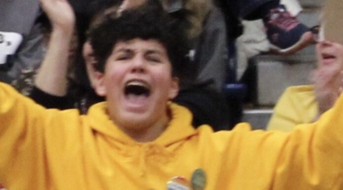 boy in yellow cheering so happy