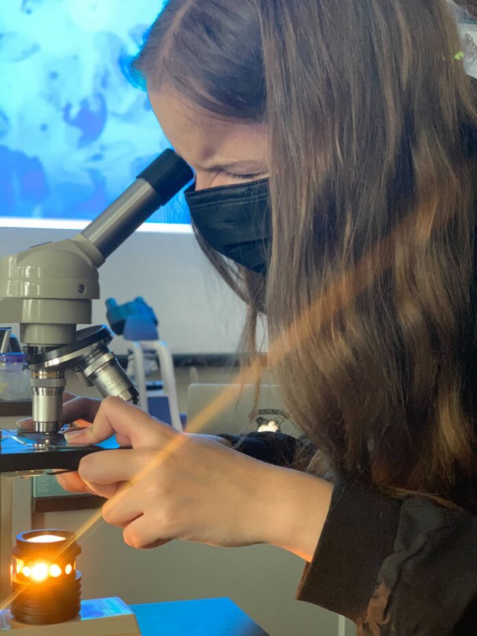 Girl Looking into a microscope