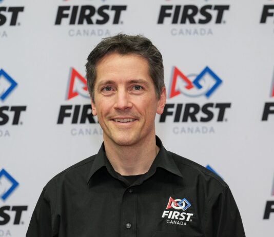 Dave Ellis in front of FIRST Canada logo