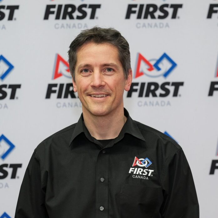 Dave Ellis in front of FIRST Canada logo