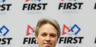 photo of mark breadner in front of FIRST Canada logo