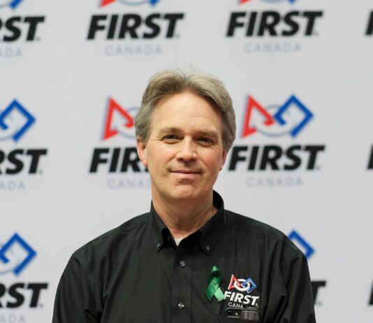 photo of mark breadner in front of FIRST Canada logo