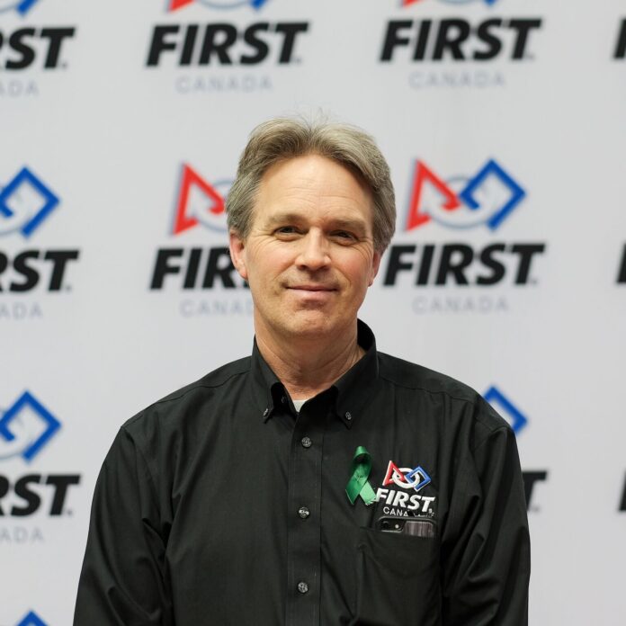 photo of mark breadner in front of FIRST Canada logo